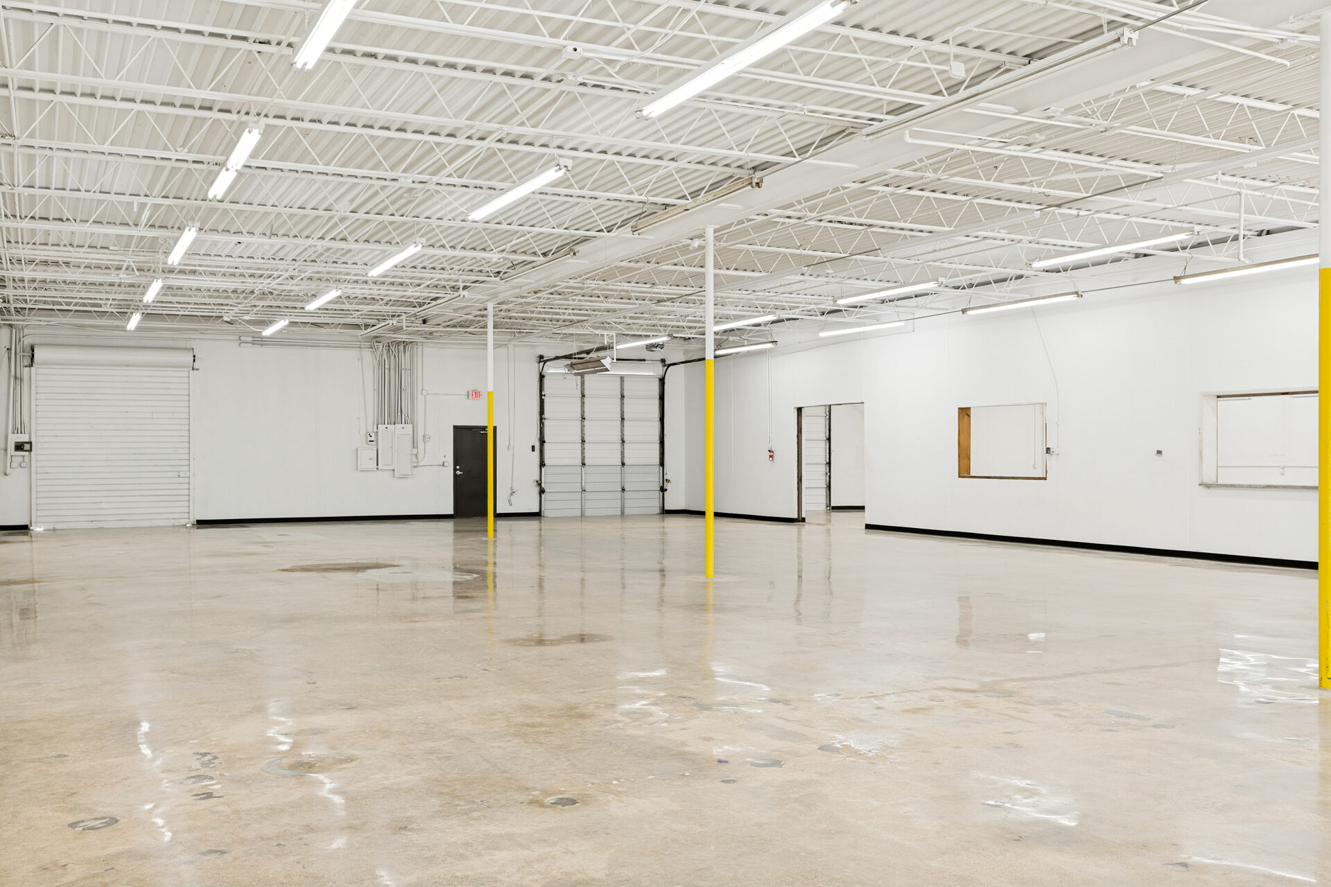 400 Bishop Ave renovation — tenant-ready warehouse interior with new overhead doors and fresh paint, Richardson TX