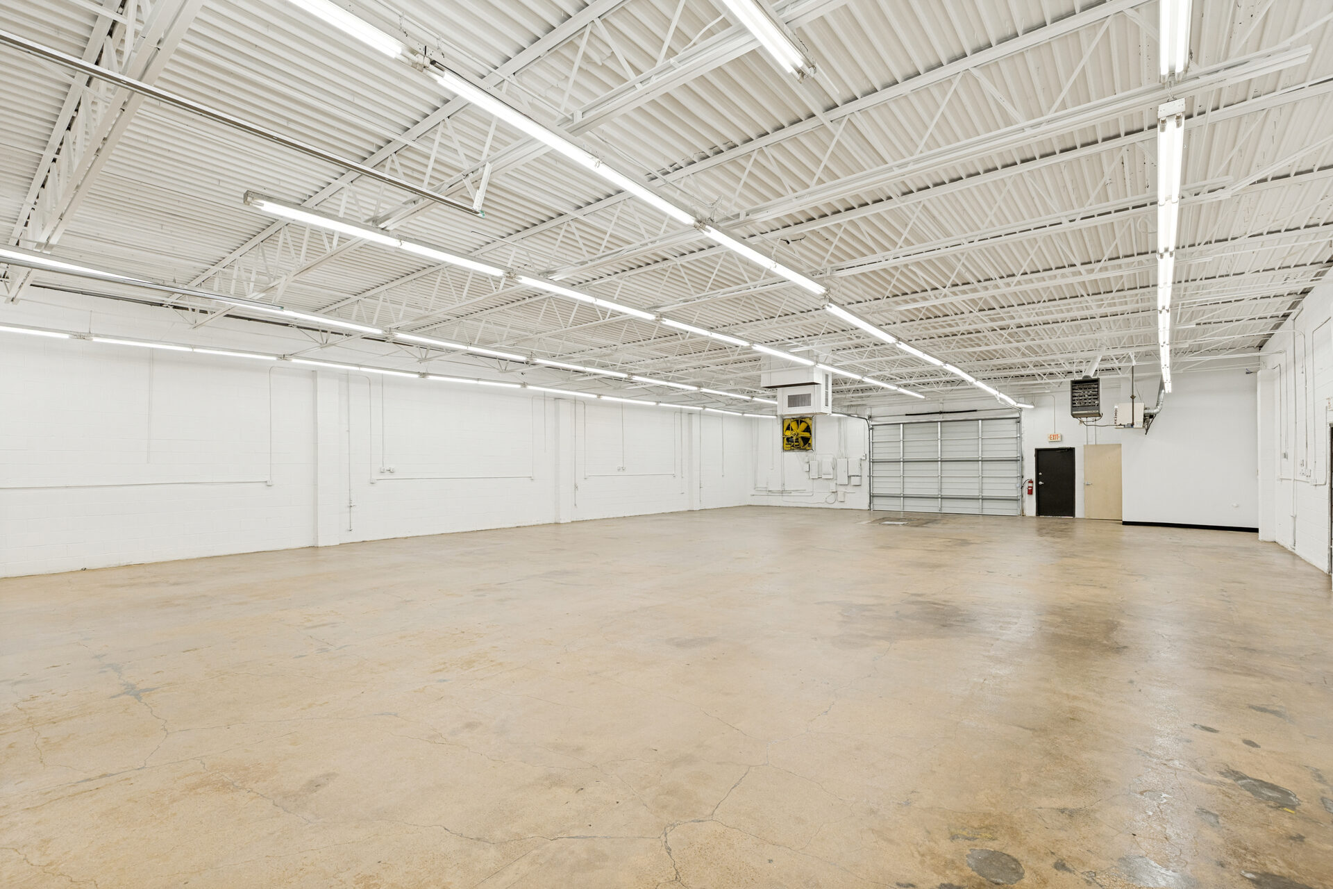 400 Bishop Ave renovation — open warehouse interior with LED lighting and fresh paint, Richardson TX