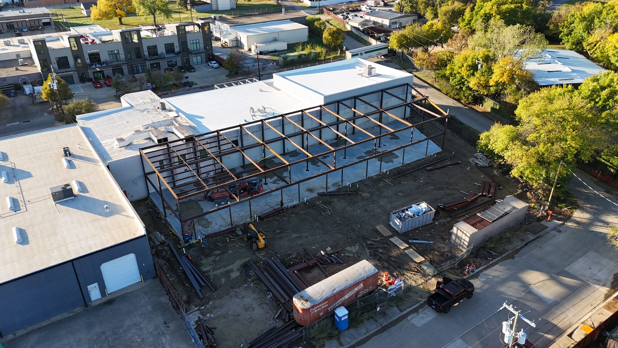 4767 Iberia construction site — structural steel frame erected, aerial view, Dallas Design District TX